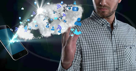 Composition of businessman using interactive screen with smartphone, cloud and digital icons. global...