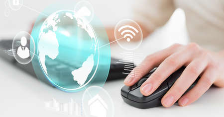 Composition of digital globe and icons over woman using mouse and keyboard. global business and...