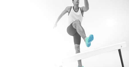 Composition of male athlete hurdle jumping with copy space on white background. sports and...