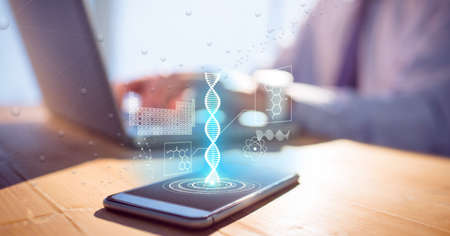 Composition of person at desk using laptop and smartphone with medical data interface on screen. global medicine, research and digital interface concept digitally generated image.の写真素材