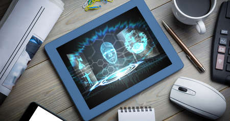 Composition of tablet on office desk with virtual medical research data interface screen. global...
