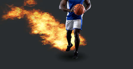 Composition of african american male basketball player holding ball with fire and copy space. sport and competition concept digitally generated image.の写真素材