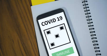Composition of smartphone with covid 19 immune text. global coronavirus pandemic, health and covid...