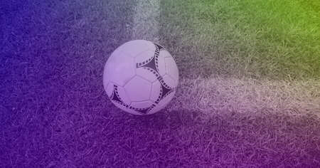 Composition of football on white line on grass pitch with copy space and purple tint. sport and...