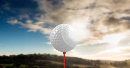 Composition of golf ball on red tee over landscape. sports and competition concept digitally generated image.の写真素材