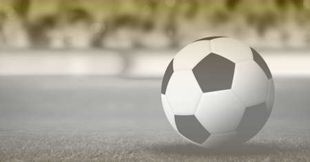 Composition of football on grass pitch with copy space. sport and competition concept digitally...