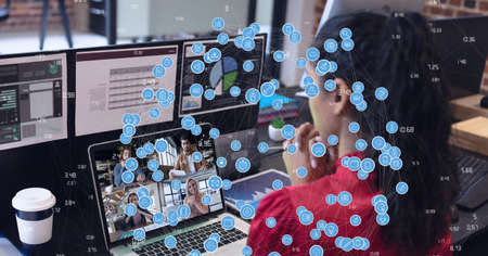 Composition of network of digital icons over businesswoman on laptop video call. global connections, technology and digital interface concept digitally generated image.の写真素材