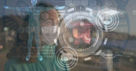 Composition of medical data processing over caucasian woman wearing face mask. global covid 19 pandemic and digital interface concept digitally generated image.の写真素材