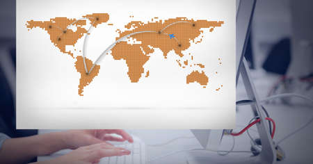 Composition of world map on interface screen over hands of woman using computer at desk in office. global communication, digital interface and business technology concept digitally generated image.の写真素材
