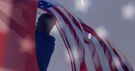 Composition of african american man holding american flag with sparkler and copy space. patriotism...