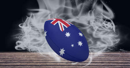 Compostion of rugby ball of australia flag on black background with white smoke. championships, sports and competition concept digitally generated image.の写真素材
