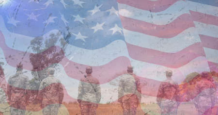 Composition of male soldiers standing at attention over american flag. patriotism and celebration concept digitally generated image.の写真素材