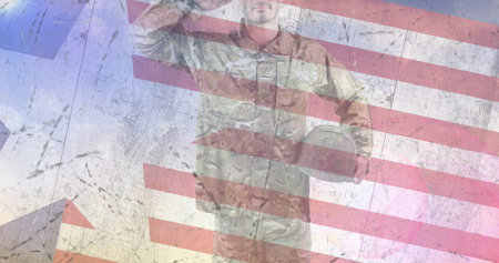 Composition of male soldier saluting over american flag. patriotism and celebration concept digitally generated image.の写真素材
