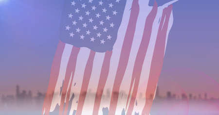 Composition of sky and cityscape over american flag. patriotism and celebration concept digitally generated image.の写真素材