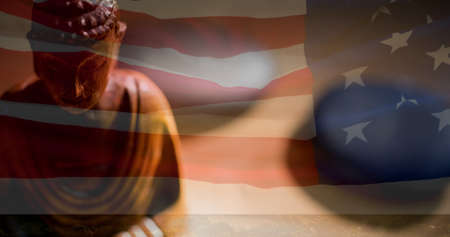 Composition of buddha figure over american flag. american patriotism and religion concept digitally generated image.の写真素材