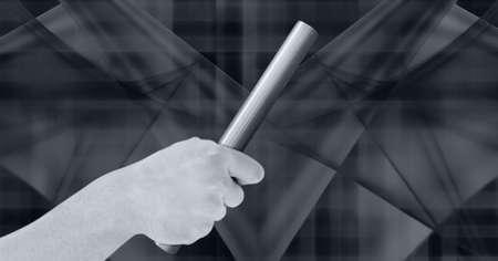 Black and white image of close up of hand holding a baton against abstract shapes on grey background. sports and fitness conceptの写真素材