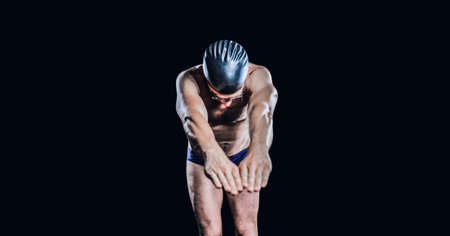 Composition of male swimmer with copy space isolated on black background. sports and competition concept digitally generated image.の写真素材