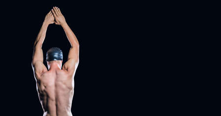 Composition of male swimmer with copy space isolated on black background. sports and competition...