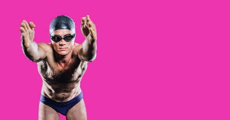 Composition of male swimmer with copy space isolated on pink background. sports and competition concept digitally generated image.の写真素材