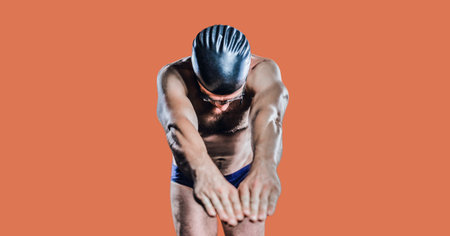 Composition of male swimmer with copy space isolated on orange background. sports and competition...