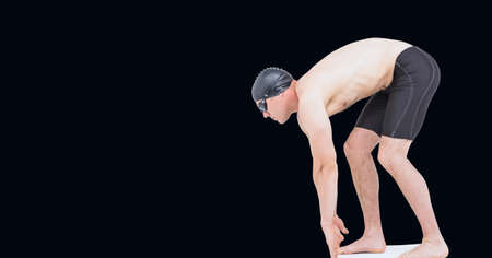 Composition of male swimmer on starting block with copy space isolated on black background. sports and competition concept digitally generated image.の写真素材