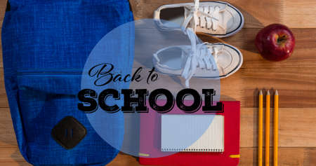 Composition of text back to school in black on schoolbag, notebook, pencils, apple and sneakers....