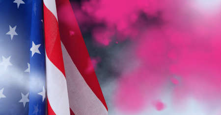 Composition of billowing american stars and stripes flag over colourful pink flare smoke. patriotism, independence and celebration concept digitally generated image.の写真素材