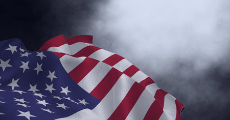 Composition of billowing american flag and smoke on dark background. patriotism, independence and celebration concept digitally generated image.の写真素材