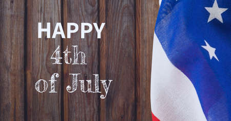 Composition of test happy 4th july in white on wood with american flag. patriotism, independence and celebration concept digitally generated image.の写真素材