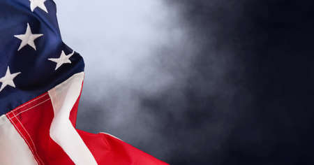 Composition of american flag and smoke on black background. patriotism, independence and celebration concept digitally generated image.の写真素材