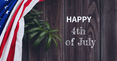 Composition of text happy 4th of july with american flag and plant on wood. patriotism, independence and celebration concept digitally generated image.の写真素材