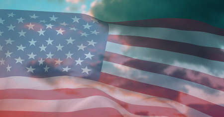 Composition of billowing american flag over cloudy blue sky. patriotism, independence and celebration concept digitally generated image.の写真素材