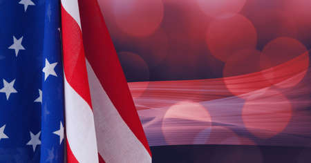 Composition of billowing american flag over defocussed red bokeh lights on dark background. patriotism, independence and celebration concept digitally generated image.の写真素材