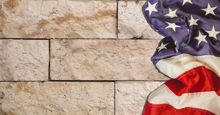 Composition of american flag on pale stone wall. patriotism, independence and celebration concept digitally generated image.の写真素材