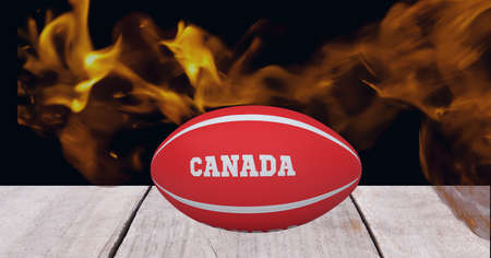 Red rugby ball with argentina text over wooden surface against fire flame effect on black background. sports tournament and competition conceptの写真素材
