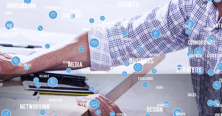 Network of digital icons and business concept texts against mid section of person using computer. global networking and business technology conceptの写真素材