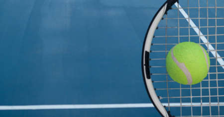Composition of tennis ball and racket with copy space on tennis court. sports and competition...