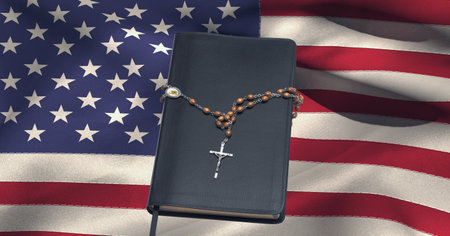 Cross rosary over bible against waving american flag in background. american patriotism and religion template background design conceptの写真素材