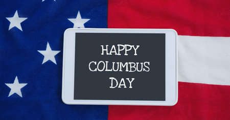 Happy columbus day text on digital tablet against american flag in background. columbus day template background design conceptの写真素材