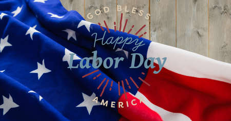 Happy labor day text against american flag on wooden background. american labor day template background design conceptの写真素材