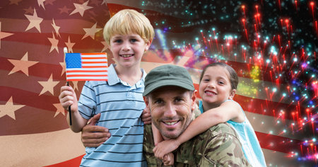 Composition of soldier with his son and daughter holding american flag over fireworks. american patriotism and independence concept digitally generated image.の写真素材