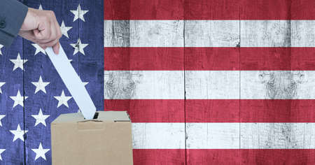Composition of man casting vote into ballot box against american flag. united states of america...