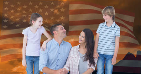 Composition of portrait of smiling caucasian couple with son and daughter against american flag. united states of america patriotism and independence concept digitally generated image.の写真素材