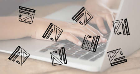 Composition of repeated rulers, pencil and eraser over hands of child using laptop. school, education and study concept digitally generated image.の写真素材