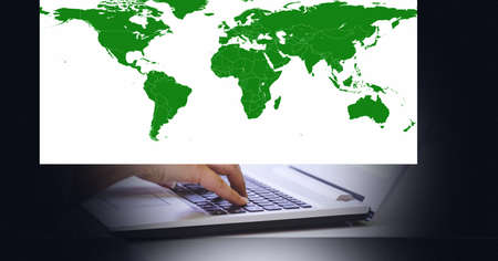 World map against mid section of person using laptop. global networking and business technology conceptの写真素材