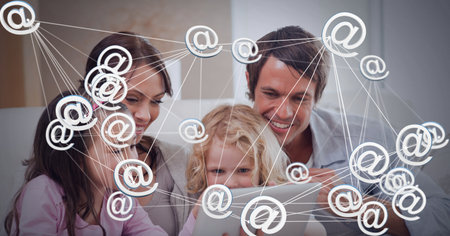 Network of connections against caucasian family using digital tablet at home. global networking and technology conceptの写真素材