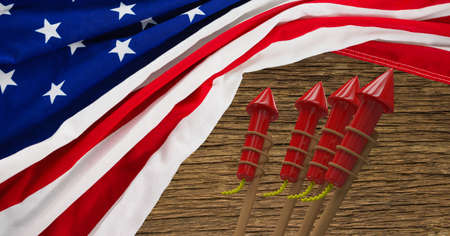 Composition of american flag with fireworks over wooden table. american patriotism, independence and celebration concept digitally generated image.の写真素材