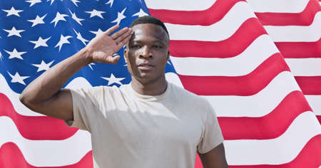 Composition of african american man saluting over american flag. american patriotism, independence and celebration concept digitally generated image.の写真素材
