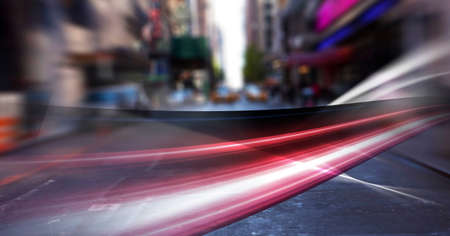 Digital composite image of red digital waves against view of city traffic. global networking and...