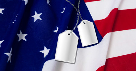 Composition of two dog tag army id&#39;s, over american flag. patriotism, independence and military concept digitally generated image.の写真素材